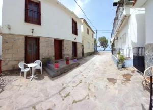 a courtyard of a building with a table and chairs at Agape’s apartment in Anaxos