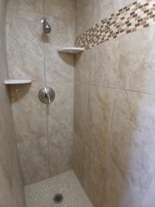 a bathroom with a shower with a tiled shower at Silver Lakes Inn in Hayden