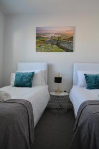 two beds sitting next to each other in a room at Normsy Place Seaside Serenity Breath Taking Views in St Bees