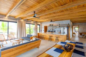 a living room with a couch and a table at Seabird Dwellings Villa with Private Splash Pool and Dock in Placencia Village