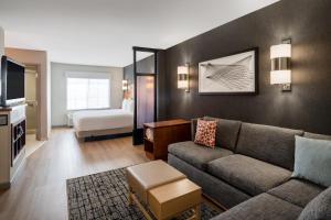 a living room with a couch and a bedroom at Hyatt Place Santa Fe in Santa Fe