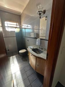 a bathroom with a sink and a toilet at Dulc in Ribeirão Preto