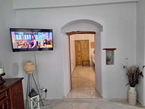 a hallway with a flat screen tv on a wall at Melissa Chora in Koufonisia