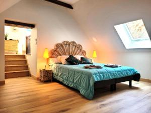 a bedroom with a bed with a headboard and stairs at Gîte de France Gîte le petit air 3 épis - Gîte de France 3 personnes MAE-6624 in Argentat +25 photos