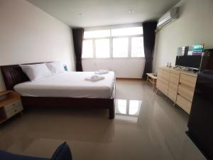 a bedroom with a large bed and a television at Proud Room &wifi 2 in Pattaya North