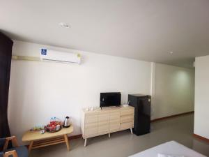a room with a refrigerator and a table in it at Proud Room &wifi 2 in North Pattaya