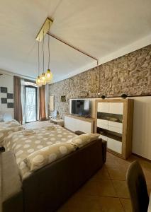 a bedroom with a large bed and a couch at Giulivi Assisi Apartments in Assisi