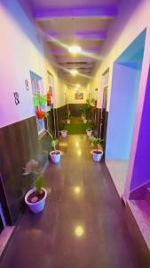 a hallway with potted plants in a room at Ram Paying Guest House & Hostel Near by Krishna Janmabhoomi GROUP OF MANAVI in Mathura