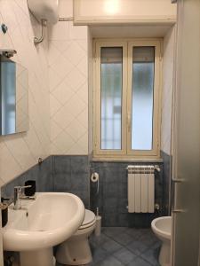 a bathroom with a sink and a toilet at ALTAMAREA appartamenti sul porto in Pozzuoli