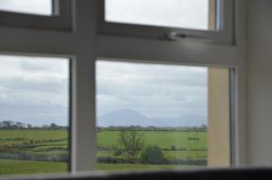 a view of a field from a window at Enniscrone Luxury Double Room in Enniscrone