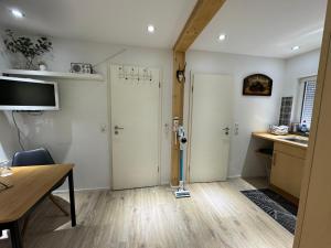 a room with two white doors and a desk at Ferienhaus Wald&Wiese in Wilzenberg-Hußweiler