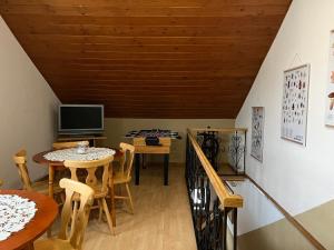 a dining room with a table and a television at Penzión D+D in Zázrivá