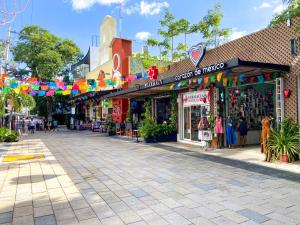 a street in a town with flags and shops at Excellent Location Studio with Roof Gym Beach at 300m in Playa del Carmen