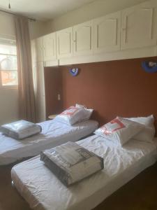 a room with two beds with bags on them at Maison à 10 m de la mer hyper centre in Les Sables-d'Olonne