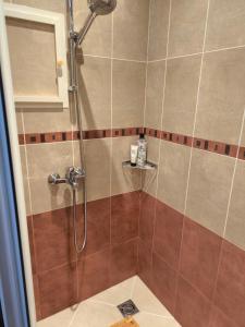 a bathroom with a shower with brown tile at Sea Bliss Retreat -Santa Marina - Sozopol in Sozopol