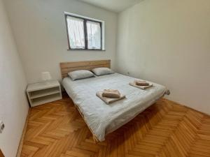 a bedroom with a bed with two towels on it at Cute & Cosy Apartment Emi in Koper