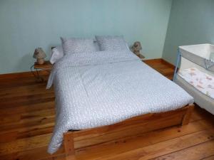 a bedroom with a bed with a white comforter at Gîte de France Le puy de diane (le dignou) 3 épis - Gîte de France 5 personn 574 