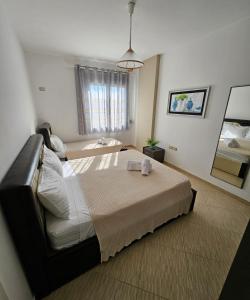 a bedroom with a large bed with a towel on it at Vacanze Pushime Albania in Radhimë