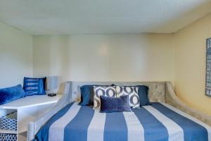 a bedroom with a bed with blue and white stripes at Albany Family Lake Getaway Near State Parks! in Albany