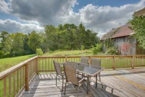a patio with a table and chairs on a wooden deck at Albany Family Lake Getaway Near State Parks! in Albany
