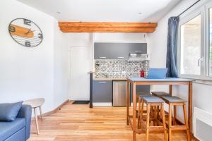 a kitchen and living room with a table and chairs at charmant T2 au bord de l'eau in Rochefort-sur-Loire
