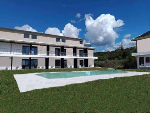 a large white building with a pool in the yard at Bella Kaliva in Kalives Poligirou