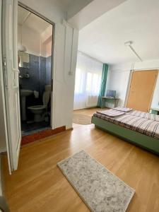 a bedroom with a bed and a bathroom with a mirror at VILA SIXTY-NINE in Eforie Sud +8 photos