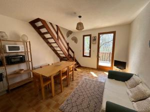un salon avec une table et un canapé dans l'établissement Six Duplex à la montagne POMPIERY, à Seyne