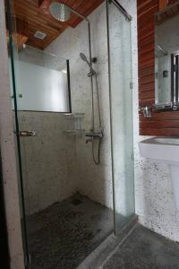 a glass shower in a bathroom with a sink at Cozy 1BR in Downtown Phnom Penh BKK2 in Phnom Penh