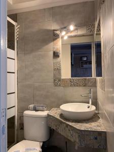 a bathroom with a sink and a toilet at Dionisos Hotel in Nei Poroi