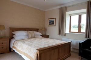 A bed or beds in a room at The Harp at Letterston