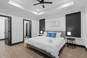 a bedroom with a large bed with blue pillows at Downtown Chattanooga that Sleeps 8 with a Pool Table in Chattanooga