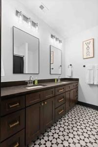 a bathroom with a sink and a mirror at Downtown Chattanooga that Sleeps 8 with a Pool Table in Chattanooga +63 photos