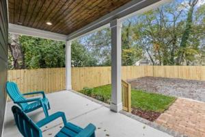 two blue chairs on a porch with a fence at Downtown Chattanooga that Sleeps 8 with a Pool Table in Chattanooga