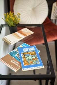 two books sitting on a glass table at BLIŻEJ GÓR Jedlina-Zdrój. Apartament na 5 in Jedlina-Zdrój