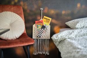 a table with a chair with a book and a fan at BLIŻEJ GÓR Jedlina-Zdrój. Apartament na 5 in Jedlina-Zdrój