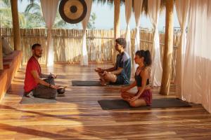 un gruppo di persone sedute a lezione di yoga di Casa Pepe a Sayulita