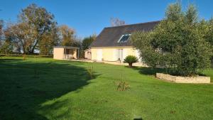 a house with a large yard in front of it at Casa DAMG in Loucelles