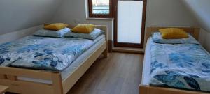 two beds sitting next to each other in a room at Domek Widokówka in Kościelisko