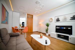 a living room with a couch and a table at Old Town Apartment in Užice +24 photos