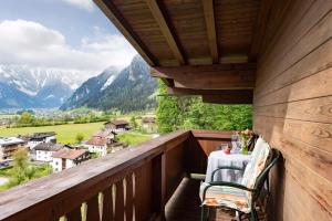 a balcony with a table and a view of mountains at Ferienhaus Am Steindl "Steindlhof" in Schwendau