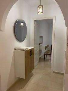 a hallway with a vanity and a mirror and a bathroom at Charme Bleue-Appartement Magique in Monastir