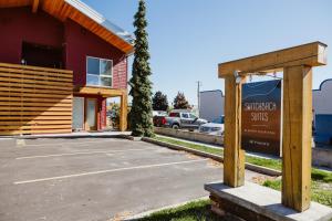 a building with a sign in front of a parking lot at Mt Merritt At Switchback Suites in Kalispell