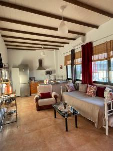 a living room with a couch and a table at Casa Rural El Miajon Apartamentos in El Campo