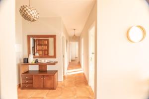 a hallway with a vanity and a mirror in a room at Apartamentos Rurales de Abelleira in Muros