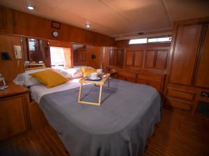 Una cama grande en un barco con una mesa. en Hyperia, en Valencia