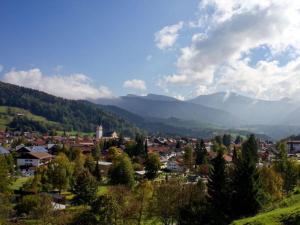 een stad in een vallei met bergen op de achtergrond bij Holiday apartment lucky guy in Oberstaufen