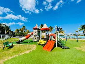 a playground with a slide and slides at Playa Blanca Founders 1 in Río Hato