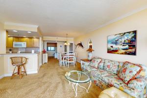 a living room with a couch and a kitchen at Sea Colony - Georgetowne House 409 in Bethany Beach