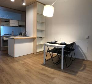 a kitchen and dining room with a table and chairs at Ring Stop Holiday Apartment 11 in Sigulda
